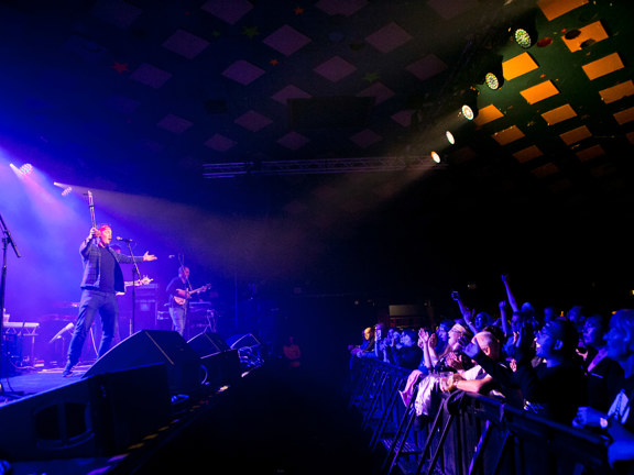 A performer sings to a cheering audience in the Barrowland Ballroom, Glasgow.