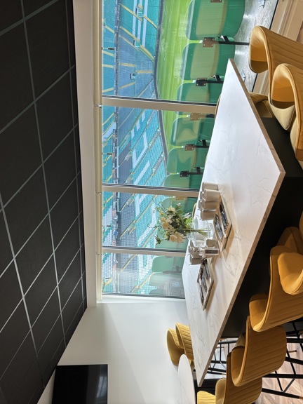 Suite that overlooks Celtic Park football stadium with table and chairs