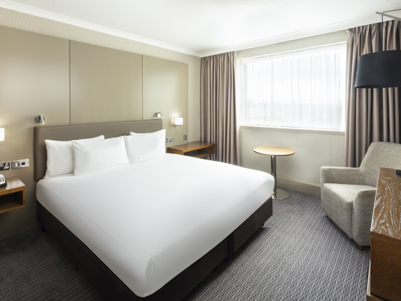 Room with king-size bed and armchair