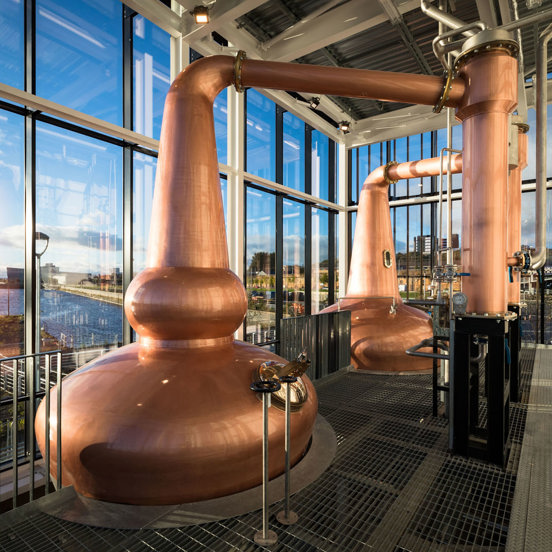 Two copper kilns with views of the River Clyde outside