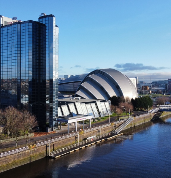 Modern glass building at the side of a river