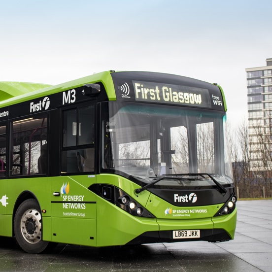 Green electric bus, with First Bus and SP Energy Networks signage