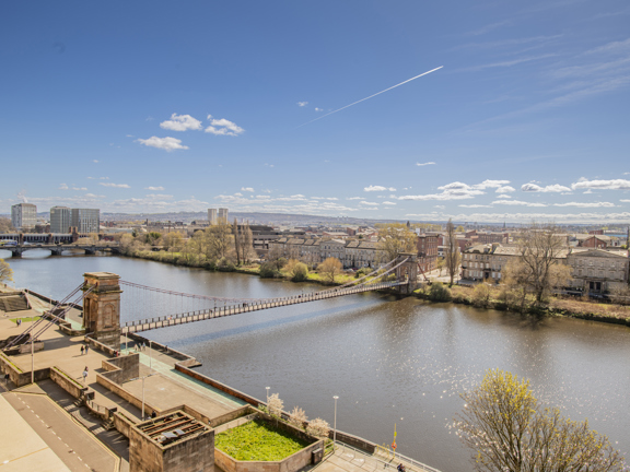 Sunny view of the River Clyde and the South bank, with the South Portland Street Suspension footbridge